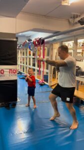 Vuxen och barn tränar thaiboxning tillsammans på Stockholm Muay Thai i Stockholm